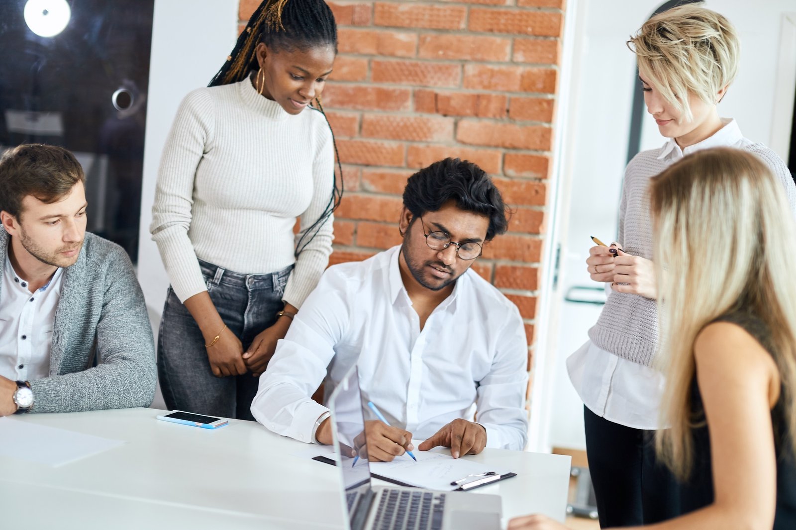 confident clever boss checking the work of his employees