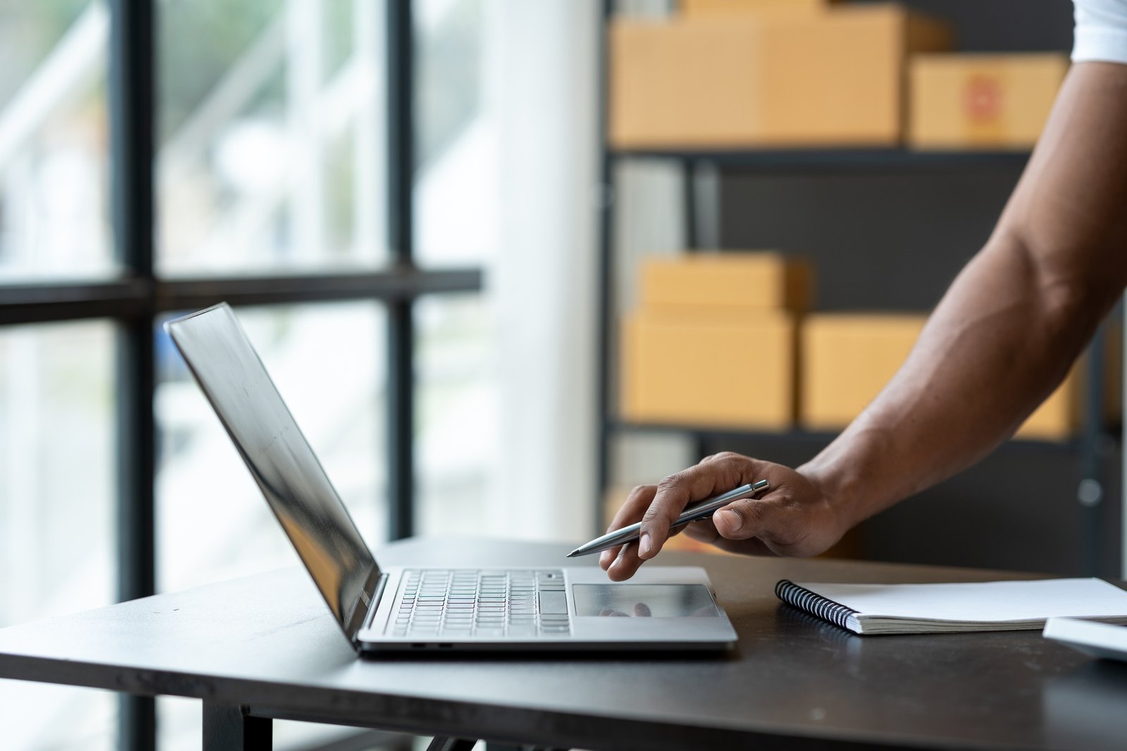 Freelance businessman checking and verifying shipping information Package boxes to prepare for deliv